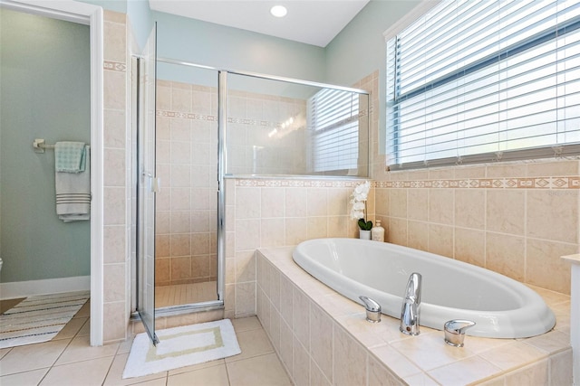 bathroom with shower with separate bathtub and tile patterned floors