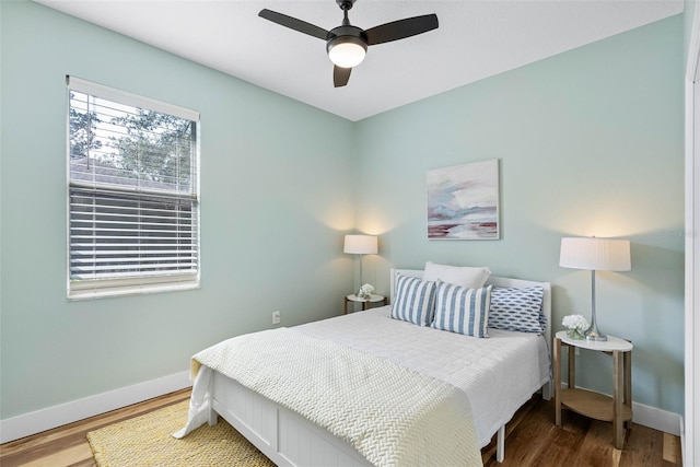 bedroom with hardwood / wood-style floors and ceiling fan