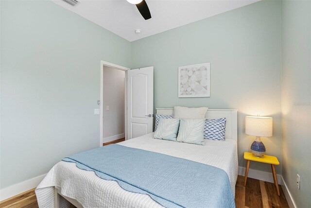 bedroom with ceiling fan and hardwood / wood-style floors