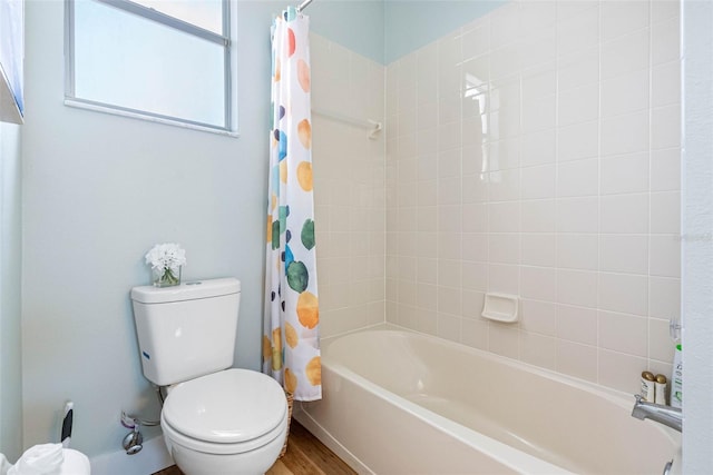 bathroom featuring hardwood / wood-style flooring, shower / tub combo, and toilet