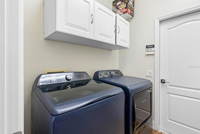 laundry room with cabinets and separate washer and dryer