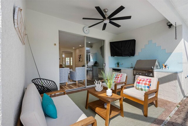 view of patio with a grill, sink, ceiling fan, and exterior kitchen