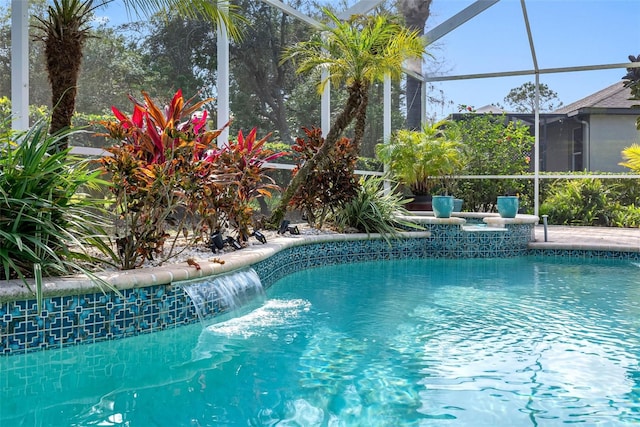 view of pool featuring a lanai and pool water feature