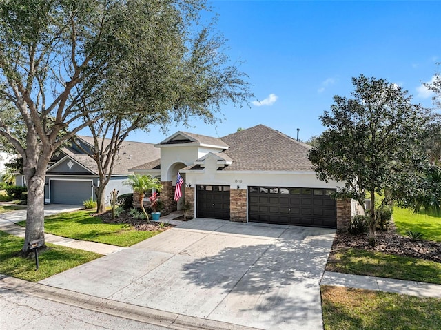 view of front of house featuring a garage and a front lawn