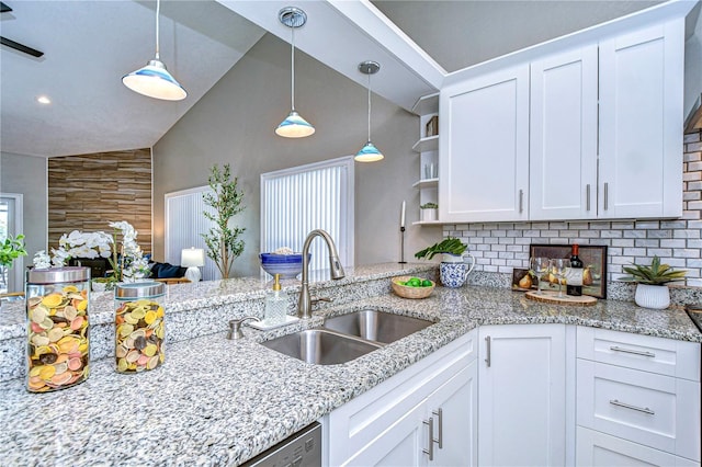 kitchen featuring pendant lighting, sink, and white cabinets