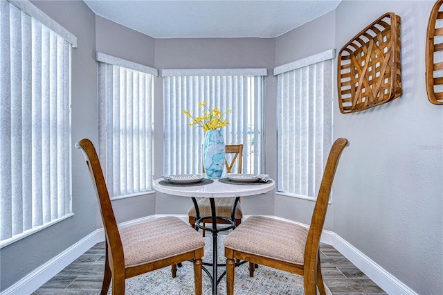 dining space with hardwood / wood-style floors