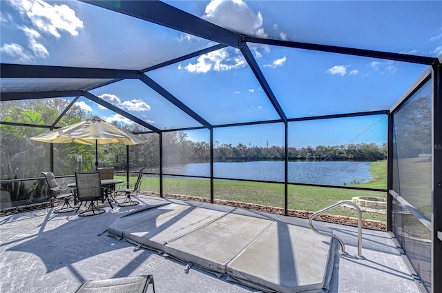 view of patio with a water view and glass enclosure