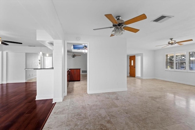 unfurnished living room with ceiling fan