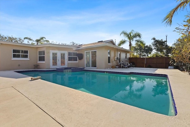 view of pool featuring a patio and french doors