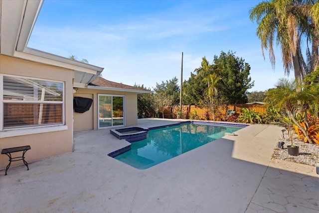 view of swimming pool with an in ground hot tub and a patio