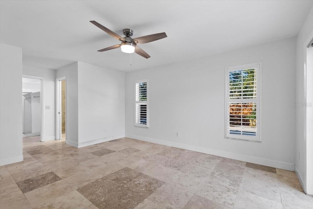 unfurnished room featuring a wealth of natural light and ceiling fan