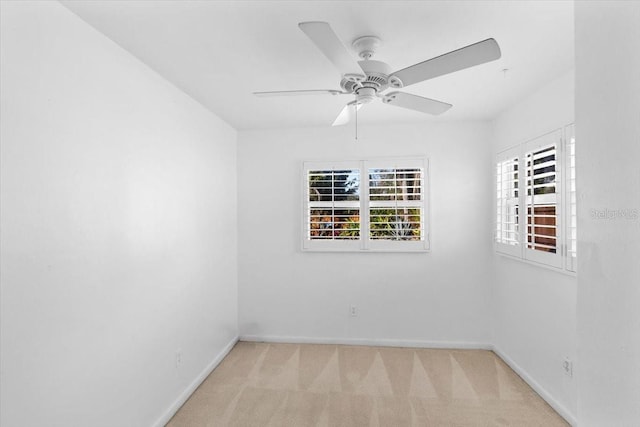 carpeted spare room with ceiling fan