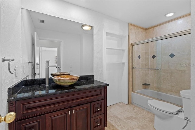 full bathroom with vanity, tile patterned floors, enclosed tub / shower combo, and toilet