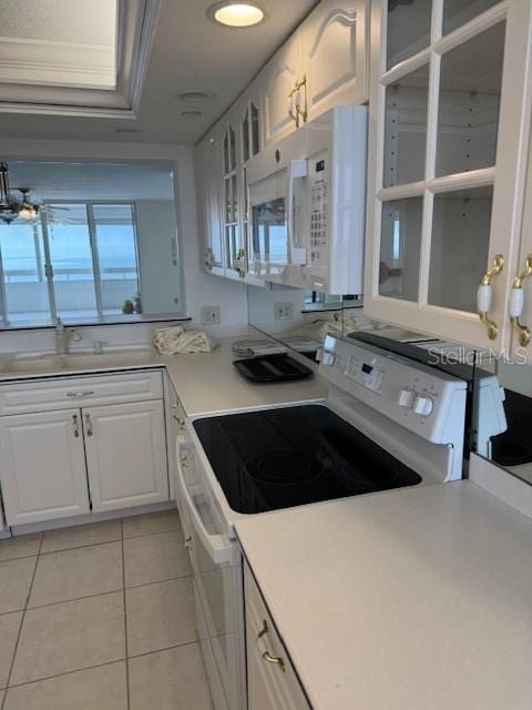 kitchen featuring white cabinetry, white appliances, and light tile patterned floors