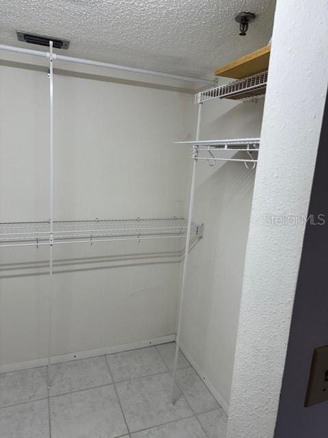 spacious closet featuring light tile patterned flooring