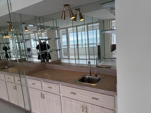 kitchen with light brown cabinetry and sink