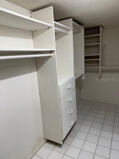 walk in closet featuring light tile patterned flooring