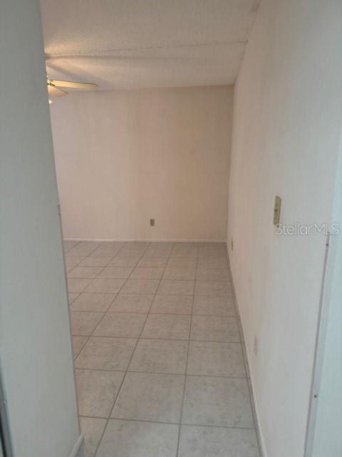 unfurnished room featuring light tile patterned floors and ceiling fan