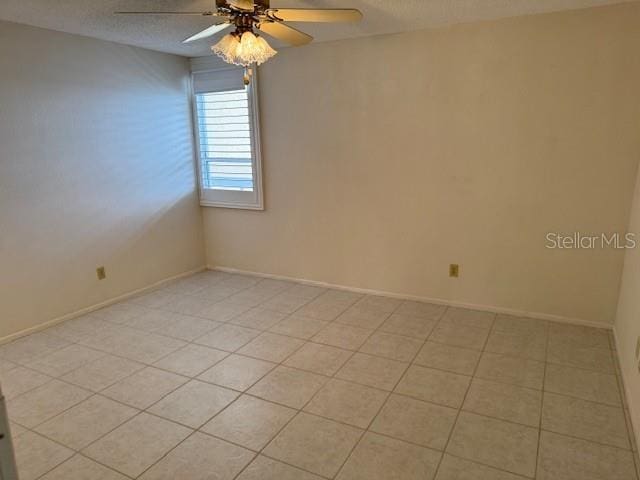 spare room featuring a textured ceiling and ceiling fan