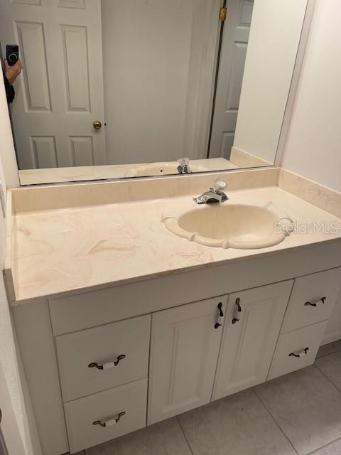 bathroom featuring tile patterned flooring and vanity