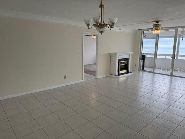 unfurnished living room with light tile patterned flooring, ornamental molding, and ceiling fan with notable chandelier