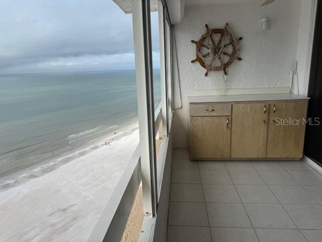 balcony with a water view and a beach view