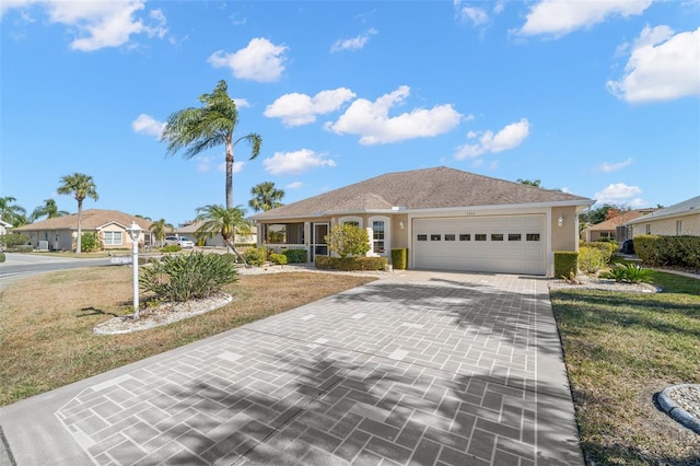 single story home with a garage and a front lawn