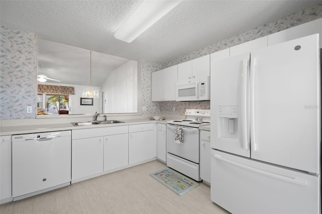 kitchen with white cabinetry, sink, white appliances, ceiling fan, and a textured ceiling