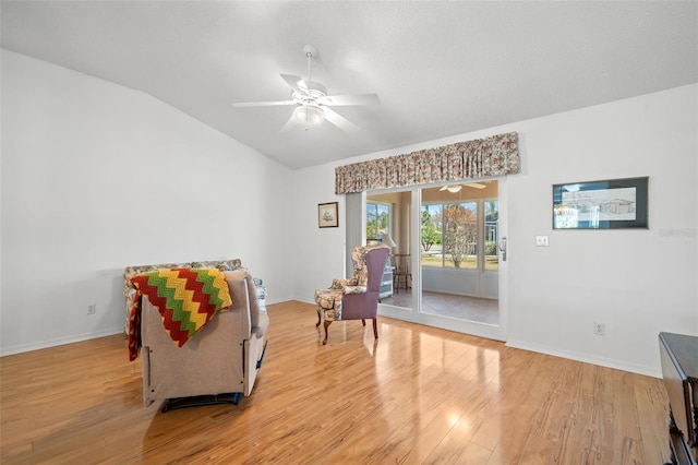 sitting room with lofted ceiling, ceiling fan, and light wood-type flooring