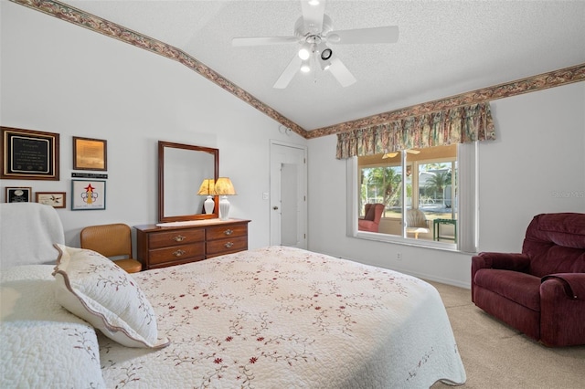 carpeted bedroom with ceiling fan, lofted ceiling, and a textured ceiling