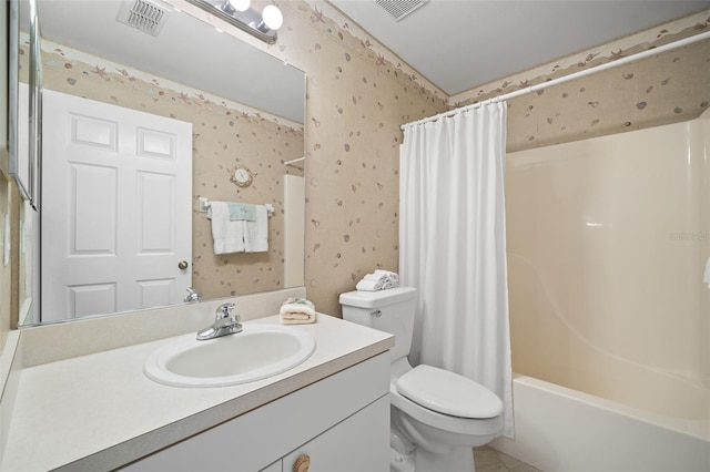 full bathroom featuring vanity, toilet, and shower / tub combo