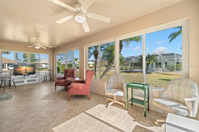 sunroom featuring ceiling fan