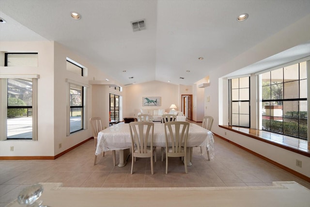 tiled dining room with vaulted ceiling