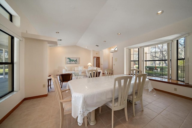 dining room with lofted ceiling and light tile patterned floors