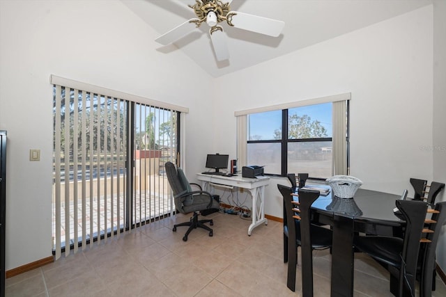 home office with plenty of natural light, high vaulted ceiling, and light tile patterned floors