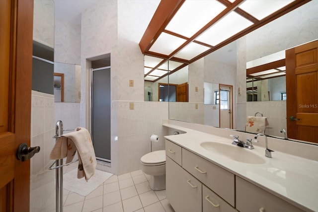 bathroom featuring tile walls, an enclosed shower, tile patterned flooring, and vanity