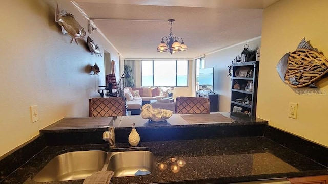 living room with sink and a notable chandelier