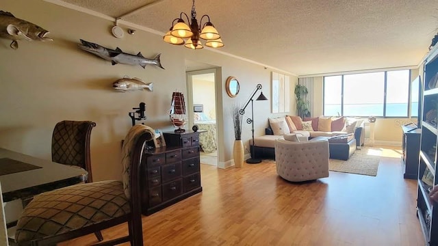 living room with hardwood / wood-style flooring, an inviting chandelier, and a textured ceiling