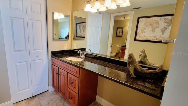 bathroom featuring vanity and toilet