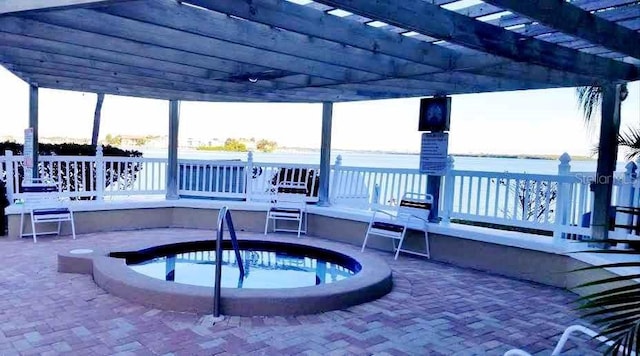 view of pool with a hot tub, a deck with water view, a patio area, and a pergola