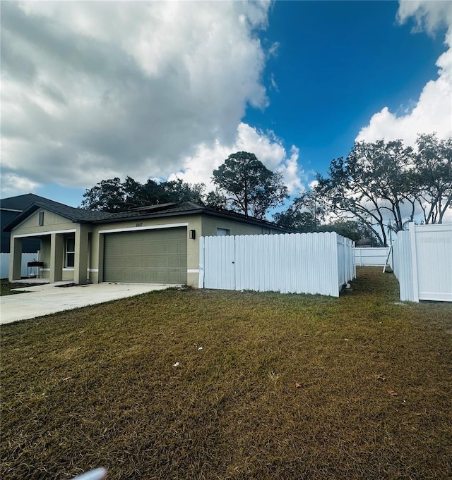 view of property exterior featuring a garage and a lawn