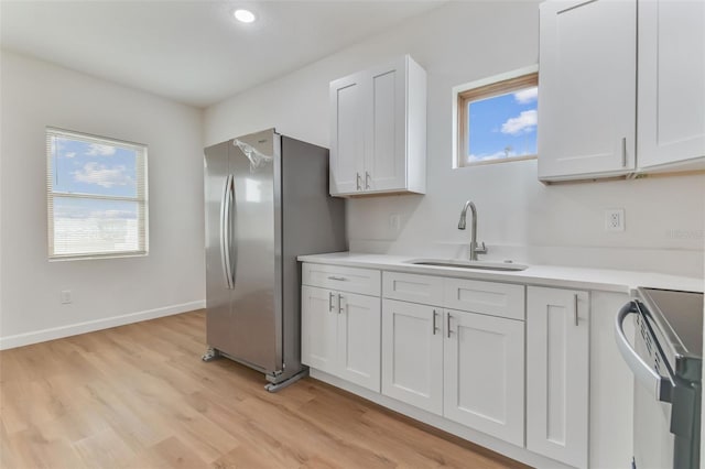 kitchen featuring white cabinetry, sink, plenty of natural light, and appliances with stainless steel finishes