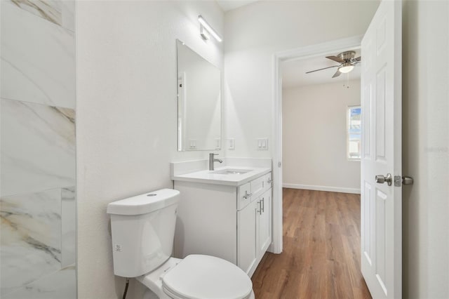 bathroom featuring vanity, hardwood / wood-style floors, toilet, and ceiling fan