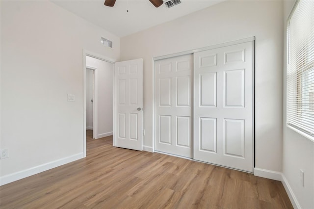 unfurnished bedroom featuring ceiling fan, light hardwood / wood-style floors, and a closet