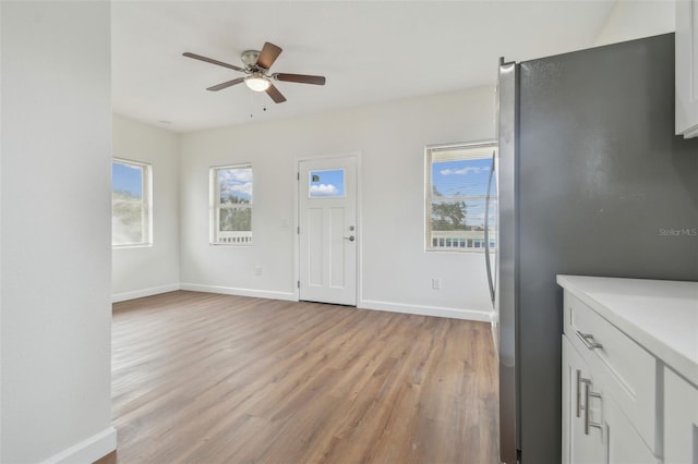 entryway with ceiling fan and light hardwood / wood-style floors