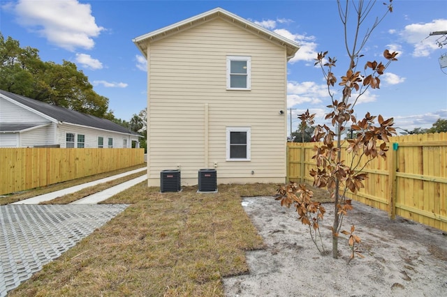 view of side of home with central AC