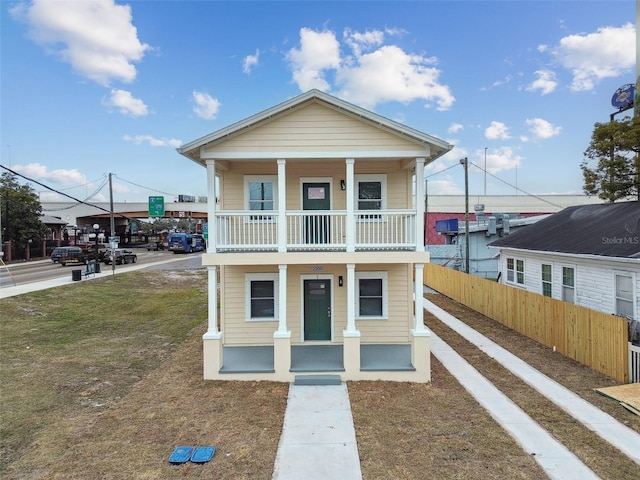 view of front facade featuring a balcony and covered porch