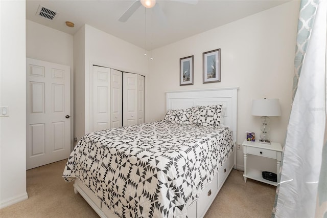 carpeted bedroom featuring ceiling fan and a closet