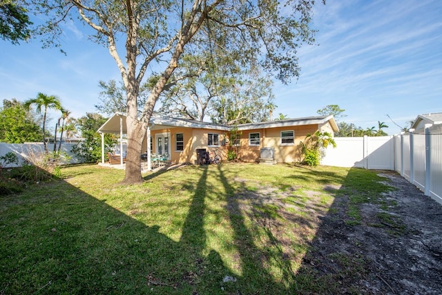 rear view of property with a lawn