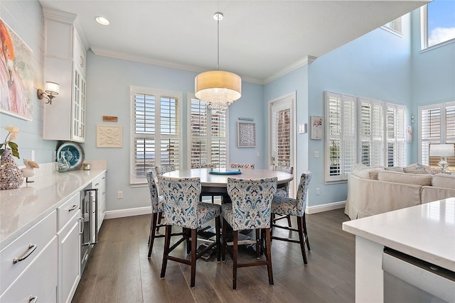 dining area with wine cooler, crown molding, dark hardwood / wood-style floors, and a healthy amount of sunlight